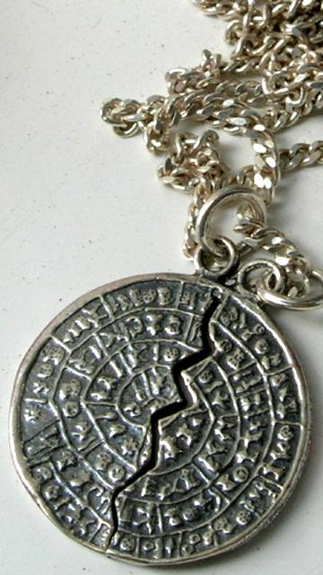 The silver Phaestos Disc pendant in Methoni